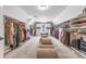 Bright walk-in closet with custom shelving and storage at 4771 Moon Chase Dr, Buford, GA 30519