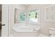 Corner soaking tub with decorative glass block window at 533 Coolsprings Walk, Woodstock, GA 30188