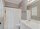 Bathroom with white fixtures, striped wallpaper, and floral trim at 533 Coolsprings Walk, Woodstock, GA 30188