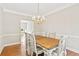 Elegant dining room with a chandelier, hardwood floors, and ample space for entertaining at 533 Coolsprings Walk, Woodstock, GA 30188