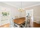 Classic dining room with hardwood floors, a chandelier, and easy access to the kitchen at 533 Coolsprings Walk, Woodstock, GA 30188
