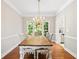 Bright dining room with hardwood floors, chandelier, and windows overlooking the backyard at 533 Coolsprings Walk, Woodstock, GA 30188