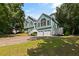 Eye-level view highlighting a charming two-story home with a two-car garage and a beautifully manicured front lawn at 533 Coolsprings Walk, Woodstock, GA 30188