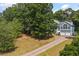 Beautifully landscaped front yard with mature trees frames this well-maintained home and two-car garage at 533 Coolsprings Walk, Woodstock, GA 30188