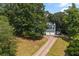 Aerial view of a well-maintained home nestled amongst mature trees on a spacious lot at 533 Coolsprings Walk, Woodstock, GA 30188