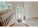 Inviting foyer features a staircase, white door with decorative glass, and elegant chandelier at 533 Coolsprings Walk, Woodstock, GA 30188