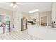 Bright kitchen with white cabinets, stainless steel appliances, and tiled floors for easy maintenance at 533 Coolsprings Walk, Woodstock, GA 30188