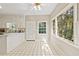 Charming kitchen featuring white cabinets, tiled floors, and large windows with natural light at 533 Coolsprings Walk, Woodstock, GA 30188