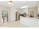 Bright kitchen with white cabinets, stainless steel appliances, and tiled floors for easy maintenance at 533 Coolsprings Walk, Woodstock, GA 30188