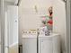 Laundry room with washer, dryer, and shelving at 533 Coolsprings Walk, Woodstock, GA 30188