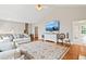Bright living room with high ceilings, hardwood floors, and comfortable couches creates a welcoming space at 533 Coolsprings Walk, Woodstock, GA 30188