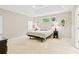 Spacious main bedroom with tray ceilings, carpeted floors, and multiple windows for natural light at 533 Coolsprings Walk, Woodstock, GA 30188