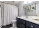 Clean bathroom featuring modern vanity and shower with a white patterned shower curtain at 115 Winding River Dr # B, Atlanta, GA 30350