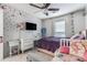 Bright bedroom featuring two beds, a ceiling fan, TV and natural light from the window at 115 Winding River Dr # B, Atlanta, GA 30350