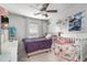 Bright bedroom featuring two beds, a ceiling fan and natural light from the window at 115 Winding River Dr # B, Atlanta, GA 30350