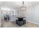An open dining area features contemporary lighting and seamless flow, perfect for modern living at 115 Winding River Dr # B, Atlanta, GA 30350