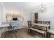 A versatile dining area features a stylish chandelier, office space, and seamless flow to the living room at 115 Winding River Dr # B, Atlanta, GA 30350