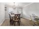 The sunlit dining space features a stylish chandelier, modern desk, and ample seating for guests at 115 Winding River Dr # B, Atlanta, GA 30350