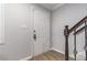 A bright entryway features wood-look flooring, a white door, and a staircase with dark wood handrail at 115 Winding River Dr # B, Atlanta, GA 30350