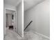 The second floor hallway features carpet, a railing, and access to bedrooms at 115 Winding River Dr # B, Atlanta, GA 30350