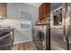 A modern kitchen features stainless steel appliances and a dedicated laundry area at 115 Winding River Dr # B, Atlanta, GA 30350