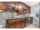 The kitchen is equipped with granite countertops, stainless steel appliances, and wooden cabinets at 115 Winding River Dr # B, Atlanta, GA 30350