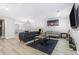 A spacious living room features modern furnishings, sleek lighting, and vinyl plank flooring at 115 Winding River Dr # B, Atlanta, GA 30350
