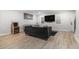 Spacious living room showcases a modern TV, a vintage arcade game, and plenty of room to relax at 115 Winding River Dr # B, Atlanta, GA 30350