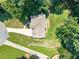 An aerial view of home showcasing the roof, driveway and lush landscaping at 3275 Cherry Oak Ln, Cumming, GA 30041
