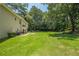 Large backyard, perfect for outdoor activities, surrounded by mature trees at 3275 Cherry Oak Ln, Cumming, GA 30041