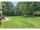 Spacious backyard surrounded by mature trees, offering plenty of room for recreation at 3275 Cherry Oak Ln, Cumming, GA 30041