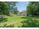 Large backyard with expansive lawn and mature trees providing ample shade at 3275 Cherry Oak Ln, Cumming, GA 30041