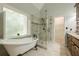 Elegant bathroom featuring a soaking tub, a glass-enclosed shower, and vanity at 3275 Cherry Oak Ln, Cumming, GA 30041