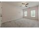 Spacious bedroom featuring neutral walls, two windows, carpet flooring, and white trim at 3275 Cherry Oak Ln, Cumming, GA 30041