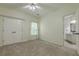 Bedroom featuring a double door closet, a window, and a view into a bathroom at 3275 Cherry Oak Ln, Cumming, GA 30041