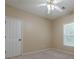 Bedroom with tan walls, white door, single window, and carpet flooring at 3275 Cherry Oak Ln, Cumming, GA 30041