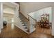 Entryway showcasing staircase, hardwood floors, and a view of the formal dining area at 3275 Cherry Oak Ln, Cumming, GA 30041
