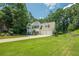 Beautiful home featuring a two-car garage, manicured lawn, and beautiful landscaping at 3275 Cherry Oak Ln, Cumming, GA 30041