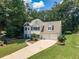 Charming home featuring a two-car garage, manicured lawn, and beautiful landscaping at 3275 Cherry Oak Ln, Cumming, GA 30041
