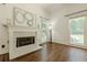 Cozy living room featuring fireplace, hardwood floors, and an abundance of natural light at 3275 Cherry Oak Ln, Cumming, GA 30041