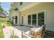 Inviting rear patio with large windows, a seating area and verdant landscaping at 3275 Cherry Oak Ln, Cumming, GA 30041