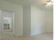 Open room with neutral paint, carpet flooring, a ceiling fan, and view of staircase at 3275 Cherry Oak Ln, Cumming, GA 30041