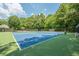 Well-maintained blue tennis courts, nestled within a wooded area in Northern Oaks, offering an active lifestyle at 3275 Cherry Oak Ln, Cumming, GA 30041
