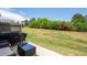 Backyard patio with outdoor seating overlooking a large grass lawn with green landscaping at 3374 Verdi Ln, Kennesaw, GA 30144