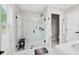 Modern bathroom featuring a frameless glass shower, white marble-style tiling, and black hardware at 3374 Verdi Ln, Kennesaw, GA 30144