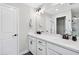 Bathroom with dual sink vanity, quartz countertop, black hardware, and a large mirror at 3374 Verdi Ln, Kennesaw, GA 30144