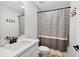 Bathroom with modern vanity, sink, and a gray and white striped shower curtain at 3374 Verdi Ln, Kennesaw, GA 30144