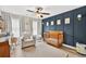 Cozy Bedroom with a crib, glider, paneled accent wall, and plenty of natural light at 3374 Verdi Ln, Kennesaw, GA 30144