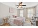 Bedroom featuring natural light, wood floors, comfortable bed and ceiling fan at 3374 Verdi Ln, Kennesaw, GA 30144