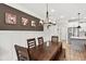 An open dining room shows a dark wood table with bench seating and a modern chandelier at 3374 Verdi Ln, Kennesaw, GA 30144